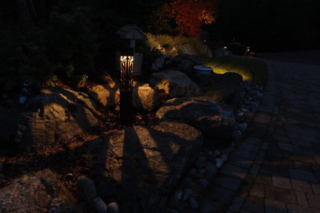 Garden rocks lit by patterned landscape light